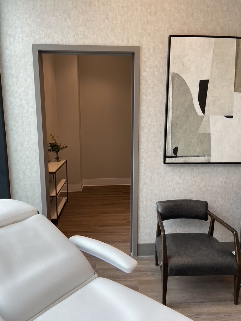 Modern medical consult room with patient chair and contemporary finishes